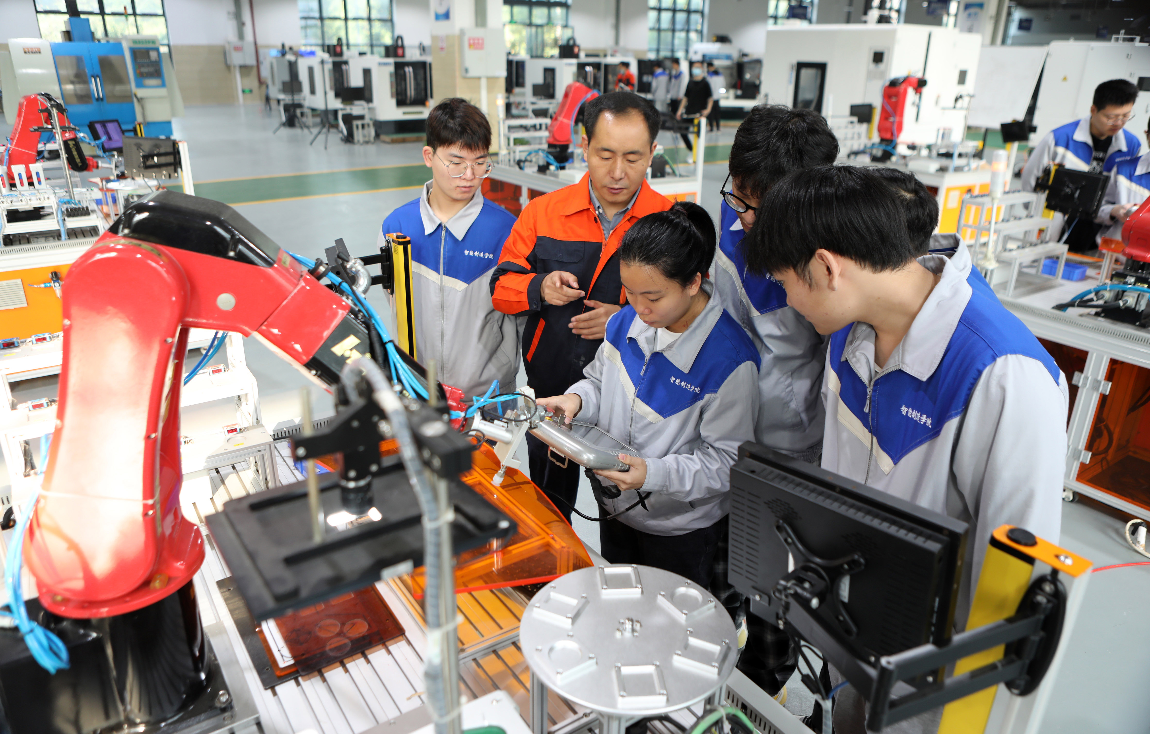 2022年10月21日,金年会工业机器人技术专业老师向学生们讲解操作技能。通讯员 陈仕川 摄 2022年10月21日,金年会工业机器人技术专业老师向学生们讲解操作技能。通讯员 陈仕川 摄